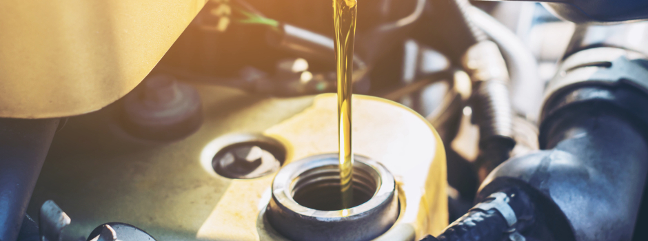 vehicle oil being poured into engine